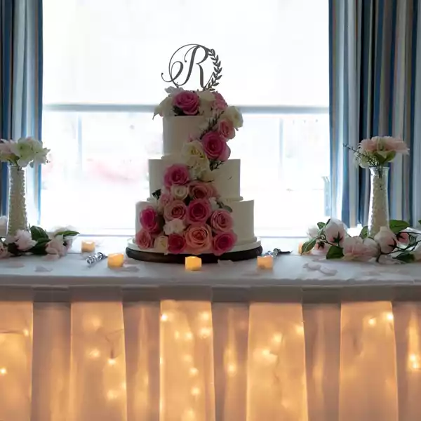 cake on table with string lights