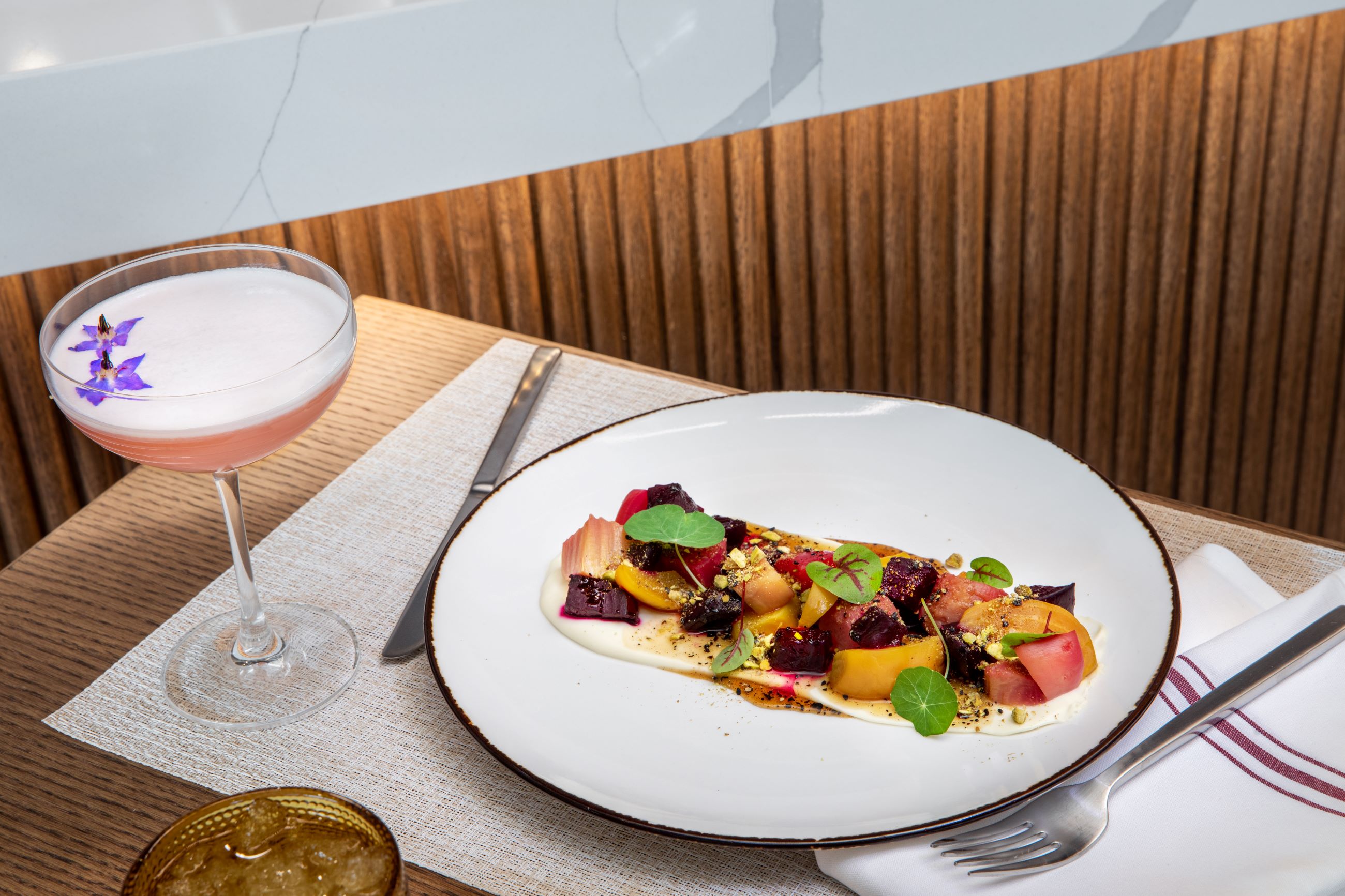 Dinner plate and drink at the Common Good restaurant