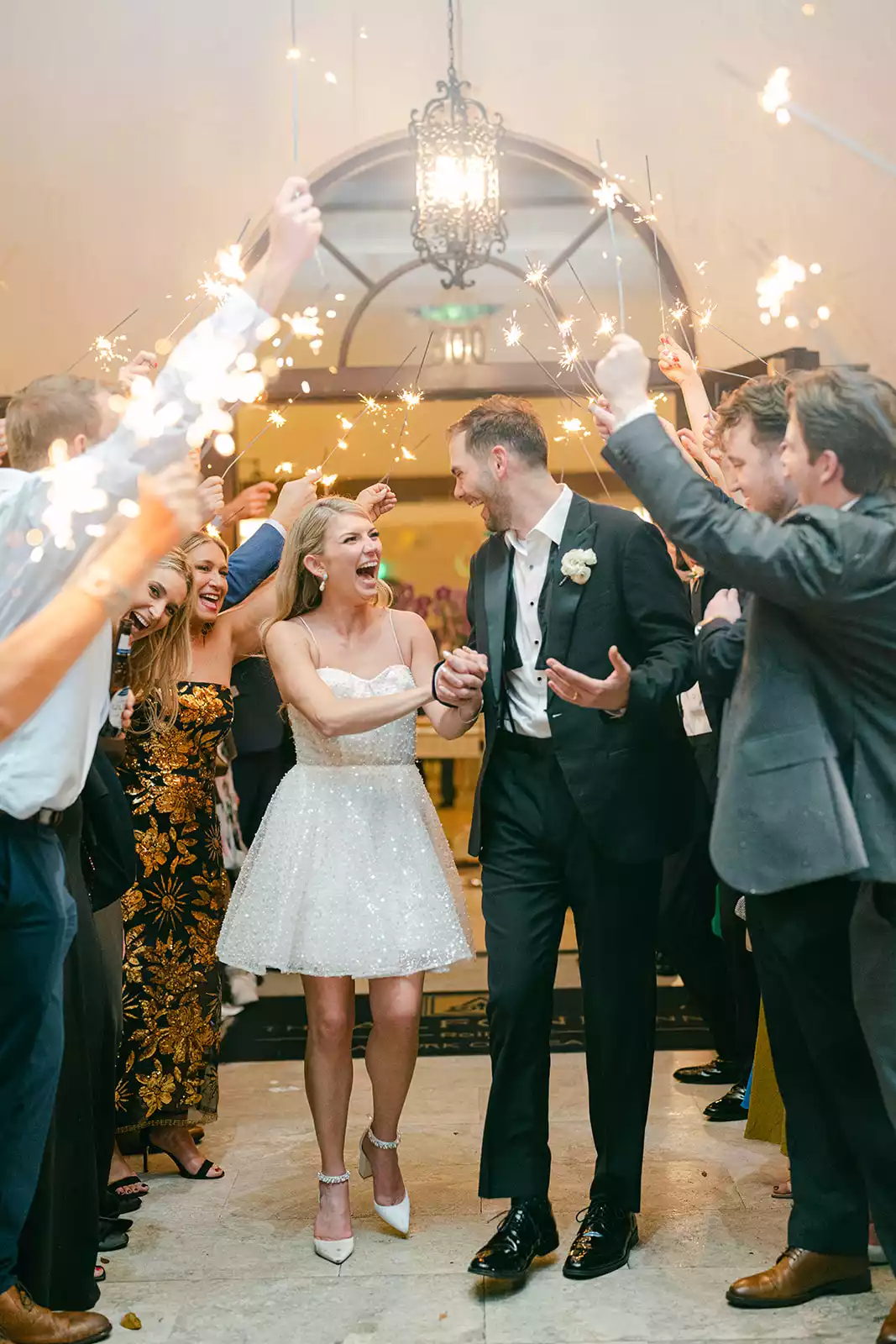 Bride and groom walking through sparkler exit