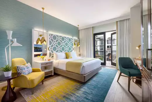 Wall art of yellow flowers and artwork displayed on a bookshelf