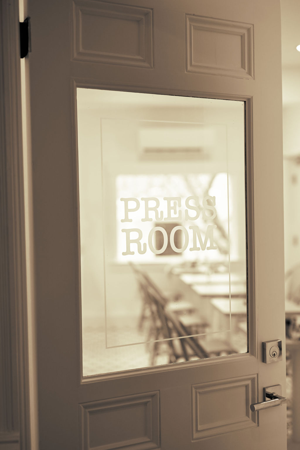 Black and white image of a door with Press Room written on the front