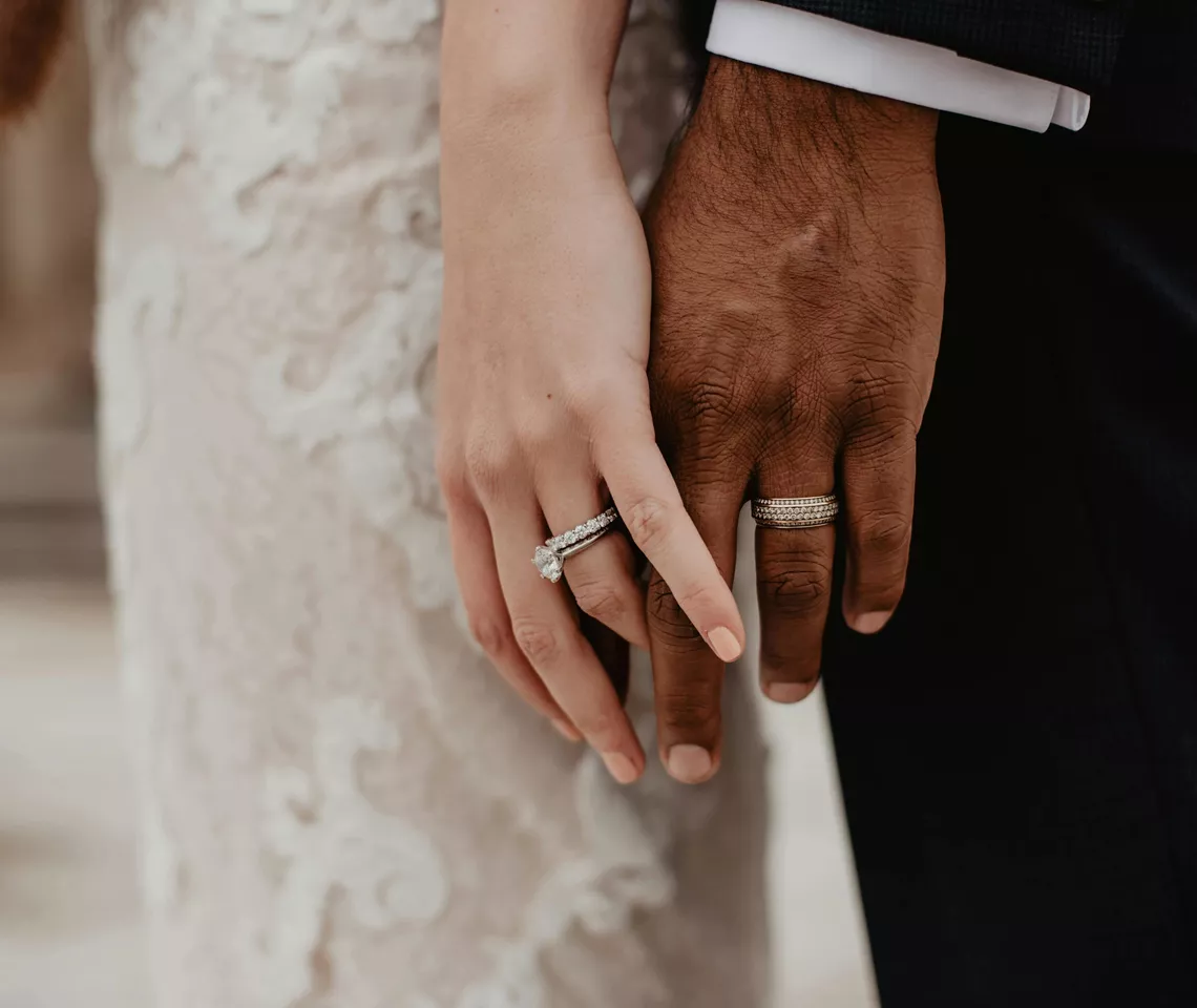 Bride and groom showing off their wedding rings