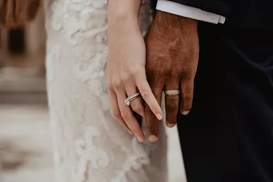 Bride and groom showing off their wedding rings
