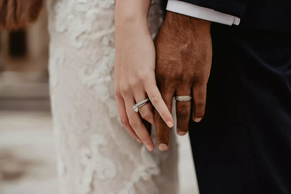 Bride and groom showing off their wedding rings