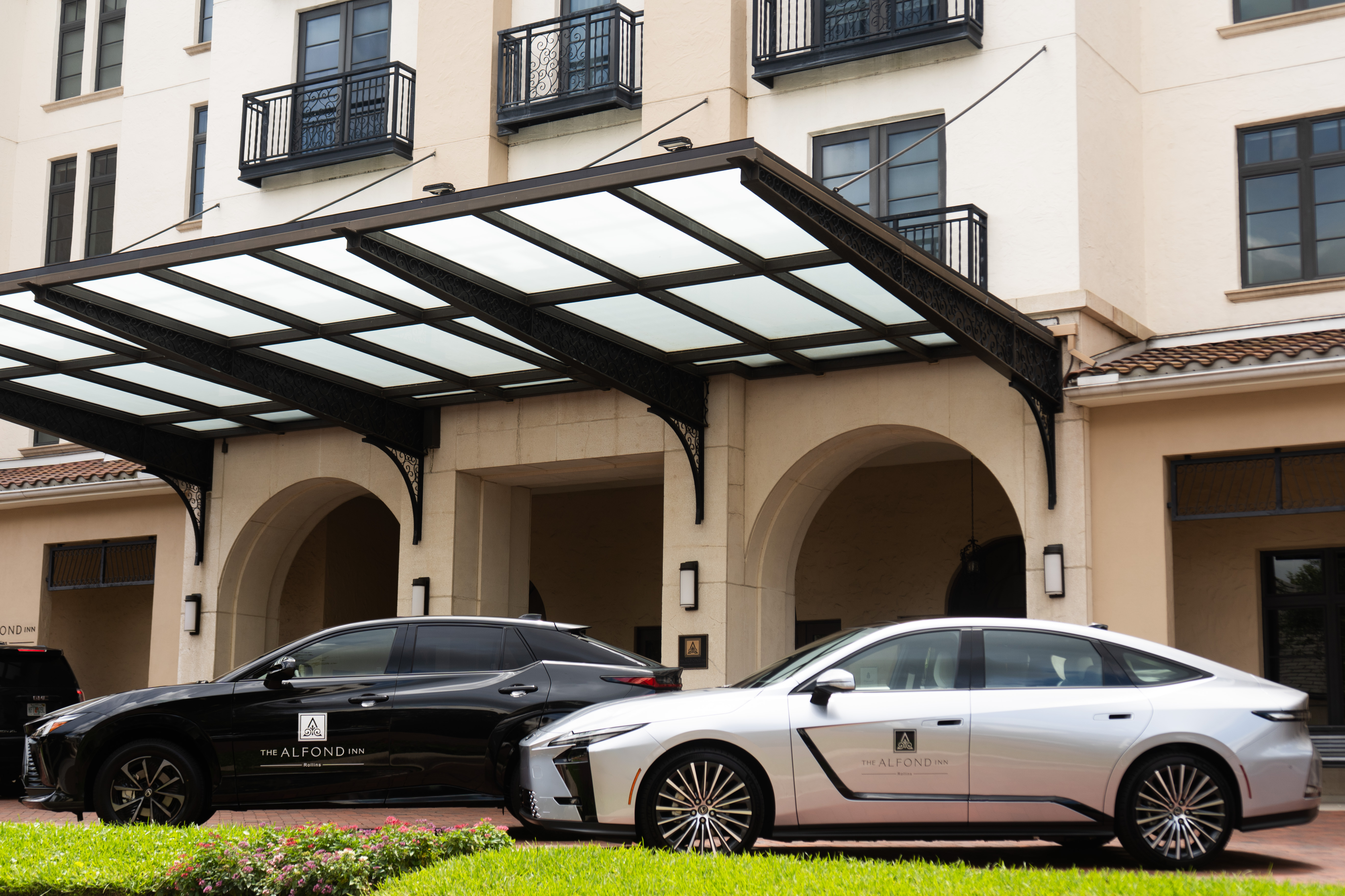 Complimentary Lexus house cars parked in the valet driveway at The Alfond Inn